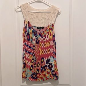 Bright colored sleeveless top with decorative back